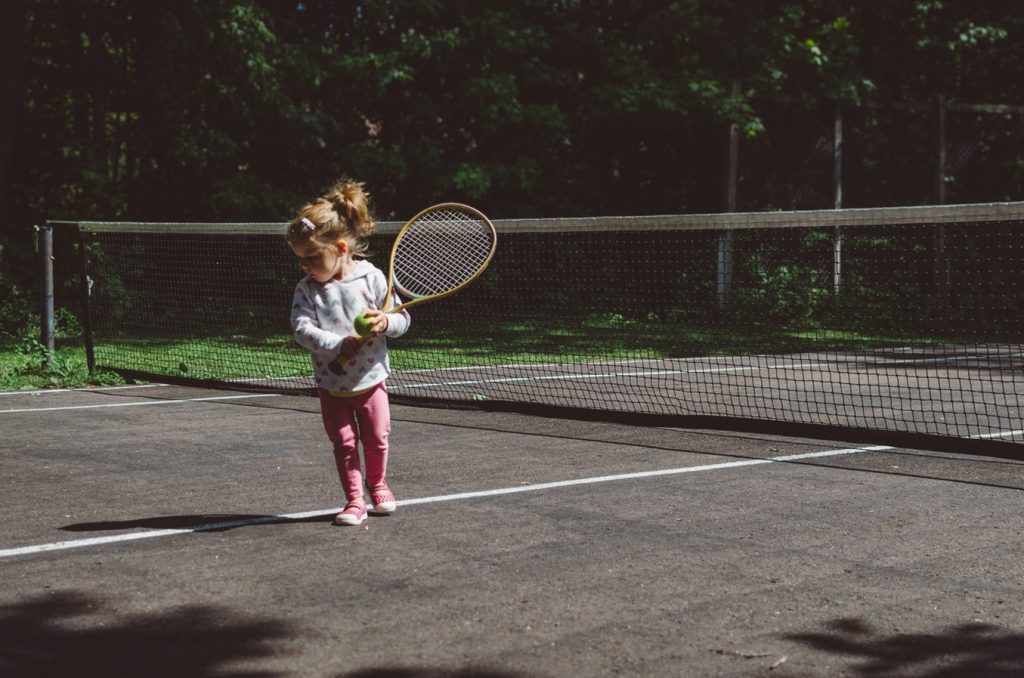 A baby girl plays tennis in Bushy Park, Dublin